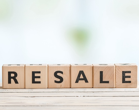 Resale Sign On A Wooden Desk